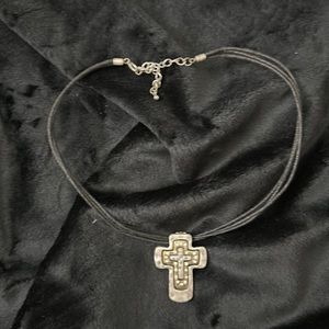 Leather necklace with two toned cross that’s removable.